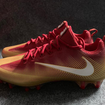 gold and red football cleats