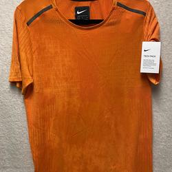 army green and orange nike shirt