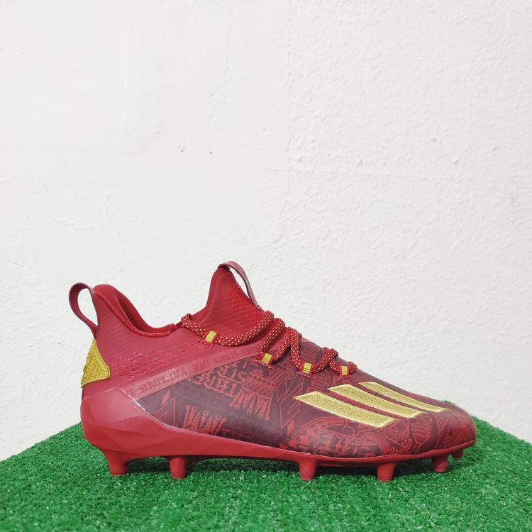 gold and red football cleats