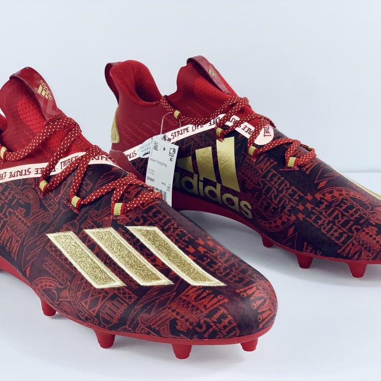 gold and red football cleats