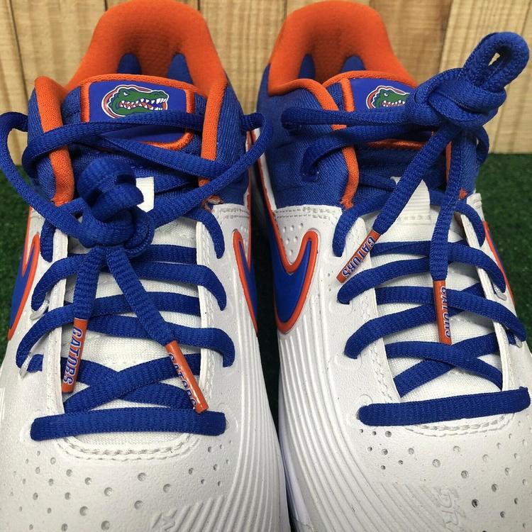 orange and blue baseball cleats
