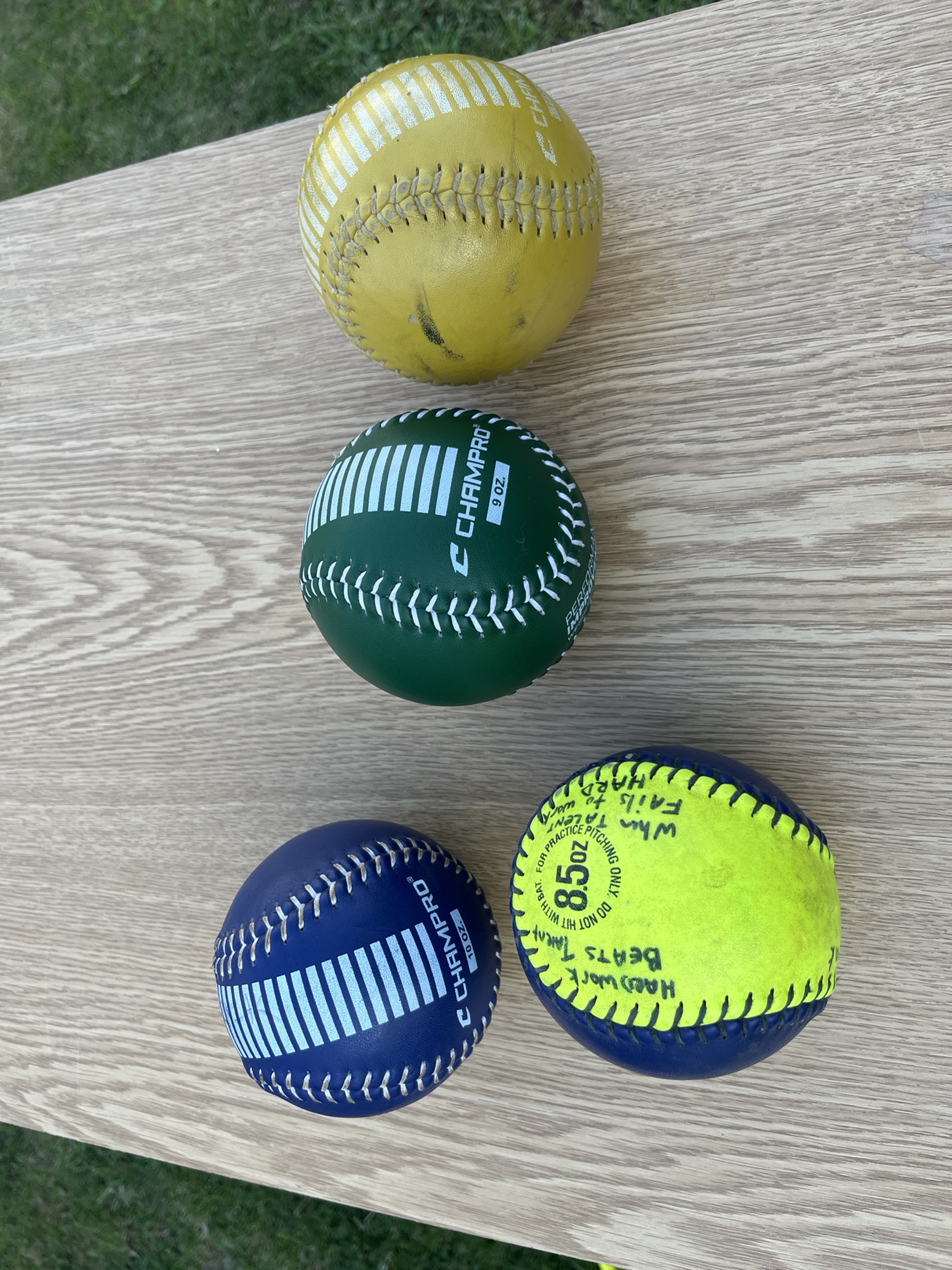 Weighted softball training balls for throwing. 8.5 oz, 9 oz, 10 oz and