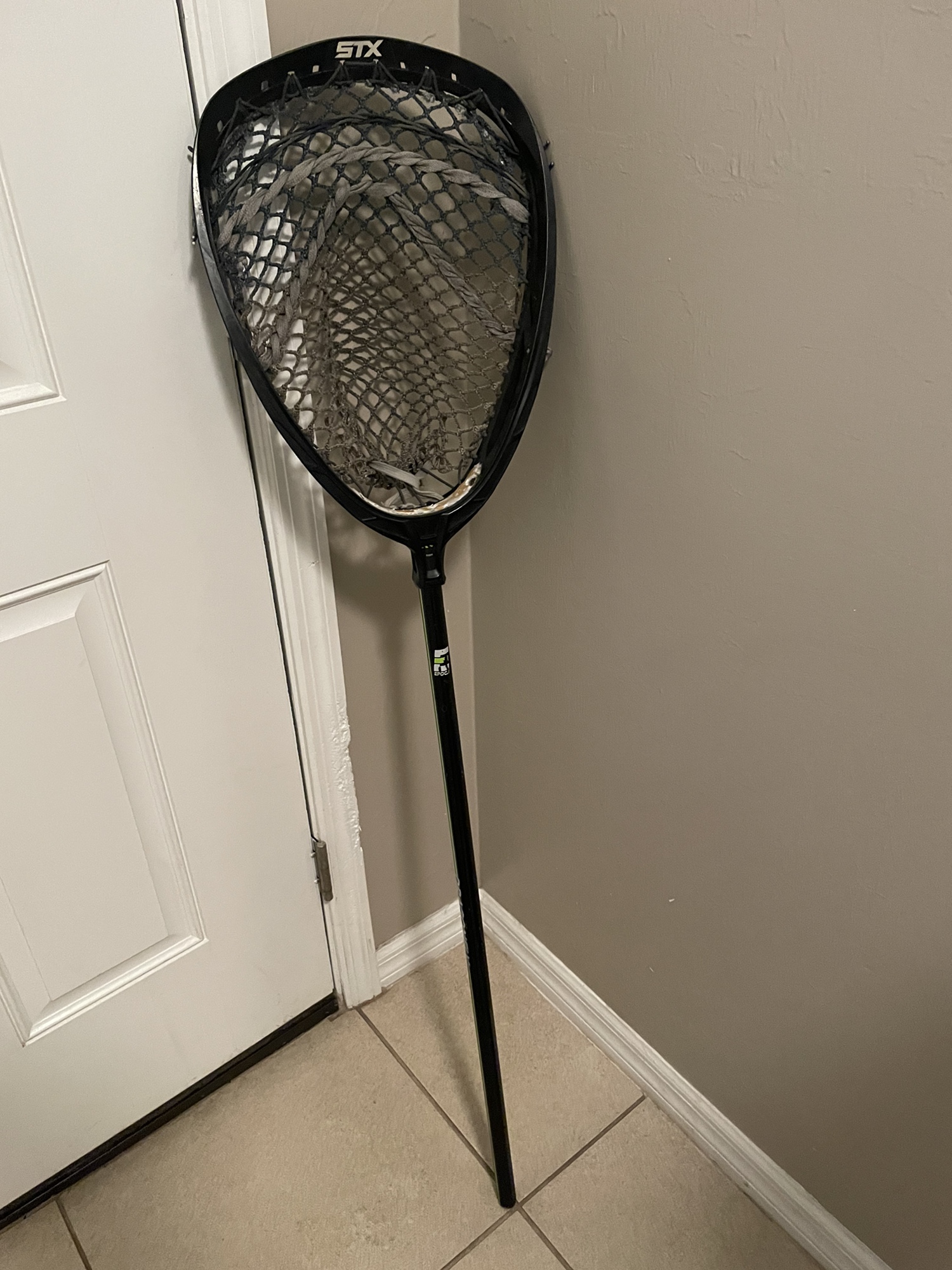 Lacrosse goalie stick with shield head monster mesh and dragonfly shaft
