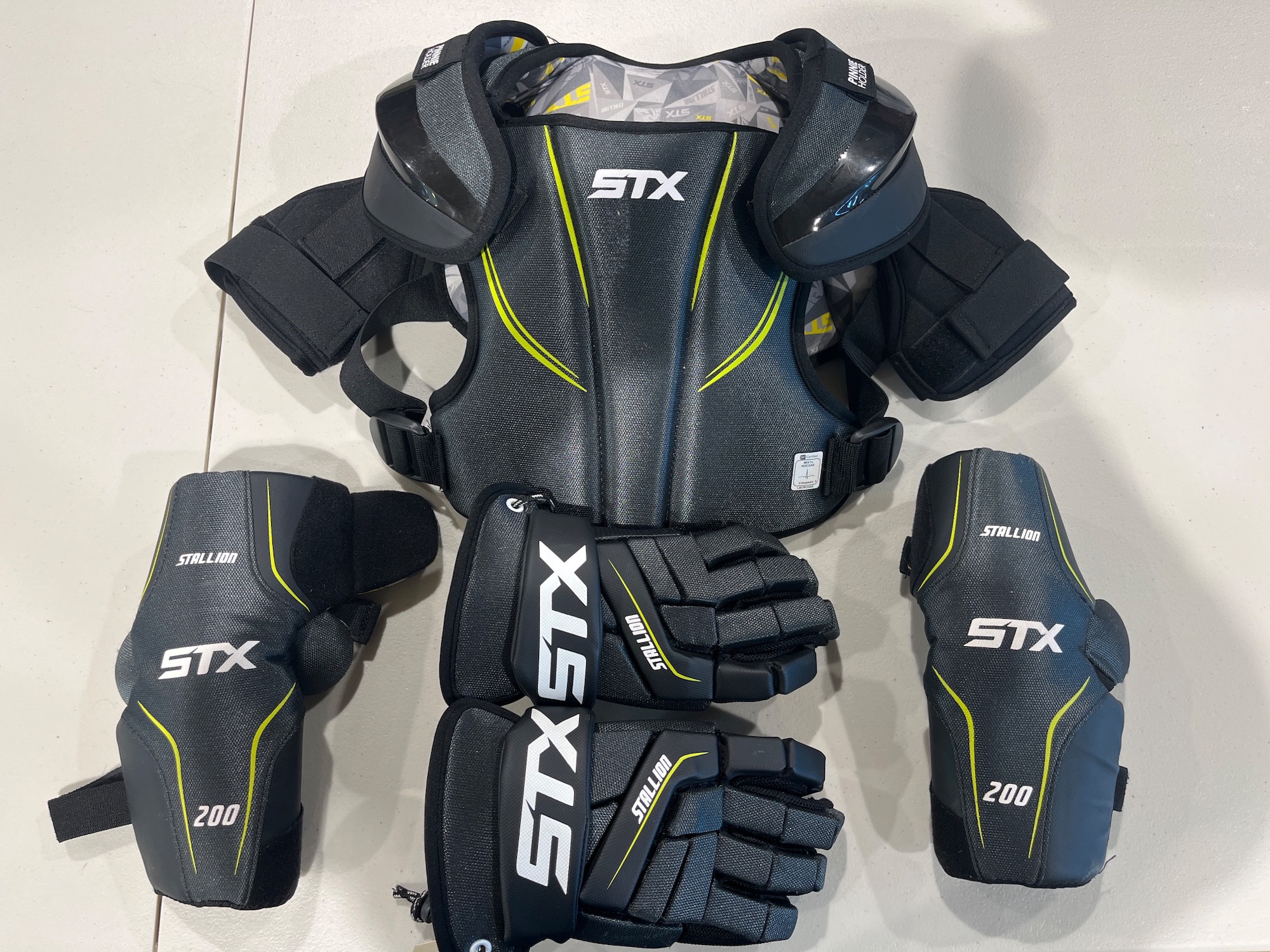 Used Medium STX Stallion 200 gloves, shoulder pads, and arm pads